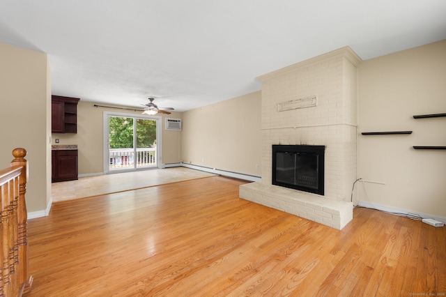 41 Laurel Leaf Dr, Ledyard, CT 06335 - unfurnished living room featuring ceiling fan, baseboard heating, light wood-type flooring, a brick fireplace, and a wall mounted air conditioner