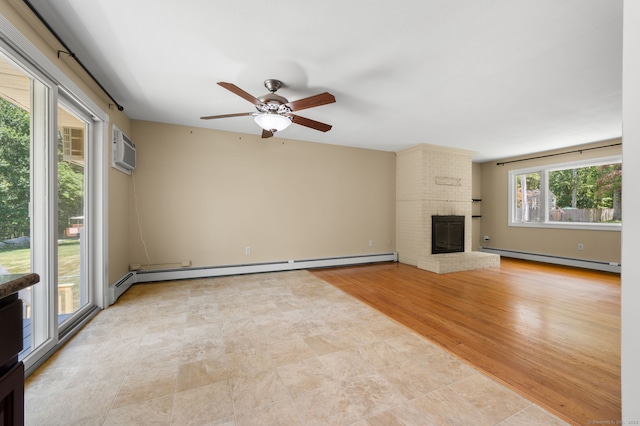 41 Laurel Leaf Dr, Ledyard, CT 06335 - unfurnished living room featuring a baseboard heating unit, a wall mounted air conditioner, a fireplace, and a ceiling fan