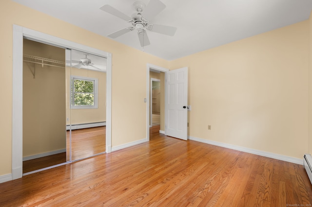 41 Laurel Leaf Dr, Ledyard, CT 06335 - unfurnished bedroom with baseboard heating, light wood-style flooring, a closet, a ceiling fan, and a baseboard heating unit