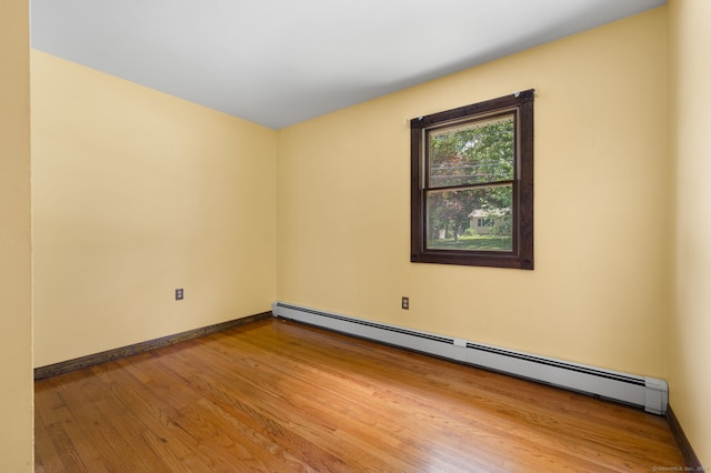 41 Laurel Leaf Dr, Ledyard, CT 06335 - unfurnished room featuring a baseboard heating unit and wood finished floors