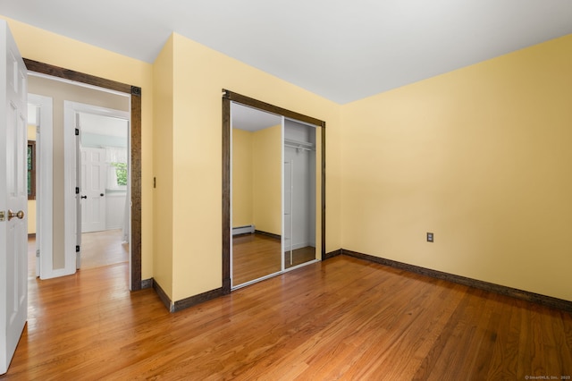 41 Laurel Leaf Dr, Ledyard, CT 06335 - unfurnished bedroom featuring light wood finished floors, baseboard heating, and a closet