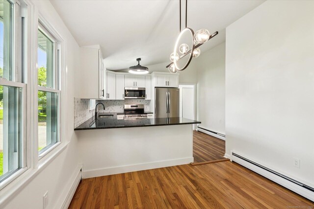 75 Atwood Hts, Thomaston, CT 06787 - kitchen with appliances with stainless steel finishes, baseboard heating, a baseboard heating unit, tasteful backsplash, and healthy amount of natural light