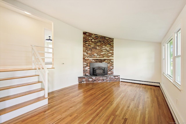 75 Atwood Hts, Thomaston, CT 06787 - unfurnished living room with a baseboard heating unit, vaulted ceiling, wood finished floors, stairs, and a wood stove