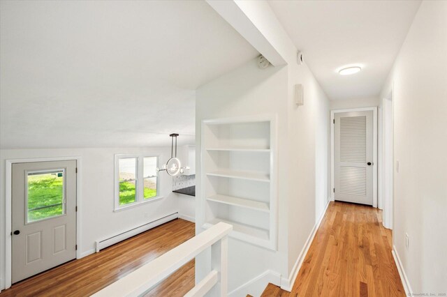 75 Atwood Hts, Thomaston, CT 06787 - hallway featuring baseboard heating, light wood finished floors, and a chandelier
