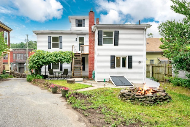105 High St, Sprague, CT 06330 - back of property with a fire pit, a chimney, and a patio area
