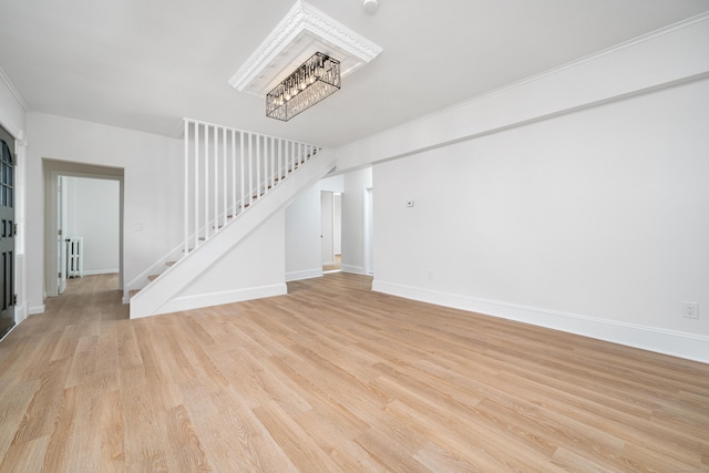 105 High St, Sprague, CT 06330 - unfurnished living room featuring radiator heating unit, a chandelier, stairs, and light wood-type flooring