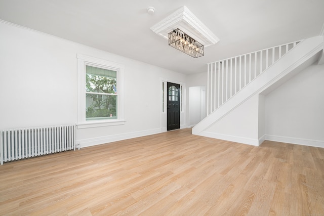105 High St, Sprague, CT 06330 - foyer entrance with radiator heating unit, stairway, a chandelier, and wood finished floors