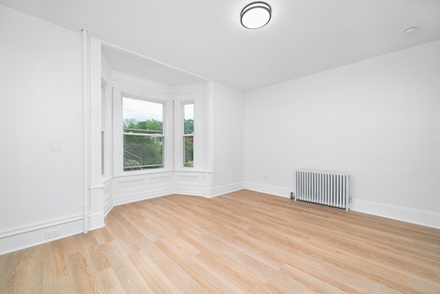 105 High St, Sprague, CT 06330 - unfurnished room featuring radiator heating unit and light wood-type flooring