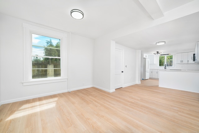 105 High St, Sprague, CT 06330 - unfurnished living room featuring light wood-style flooring and baseboards