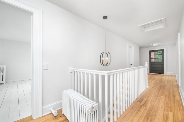 105 High St, Sprague, CT 06330 - corridor featuring an upstairs landing, light wood finished floors, and radiator heating unit