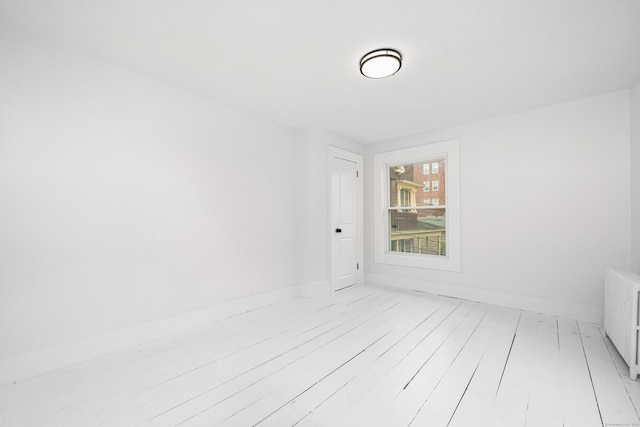105 High St, Sprague, CT 06330 - unfurnished room featuring light wood-style floors and radiator heating unit