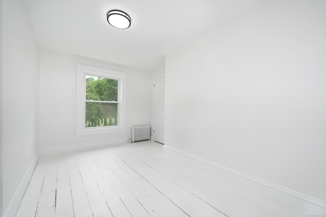 105 High St, Sprague, CT 06330 - spare room featuring radiator and hardwood / wood-style floors