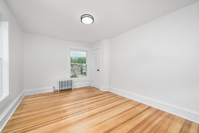 105 High St, Sprague, CT 06330 - unfurnished room with radiator heating unit and wood finished floors