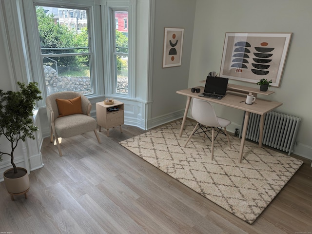105 High St, Sprague, CT 06330 - office area with radiator heating unit, healthy amount of natural light, and wood finished floors