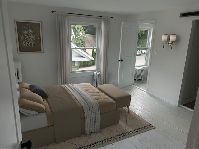 105 High St, Sprague, CT 06330 - bedroom featuring radiator and wood-type flooring