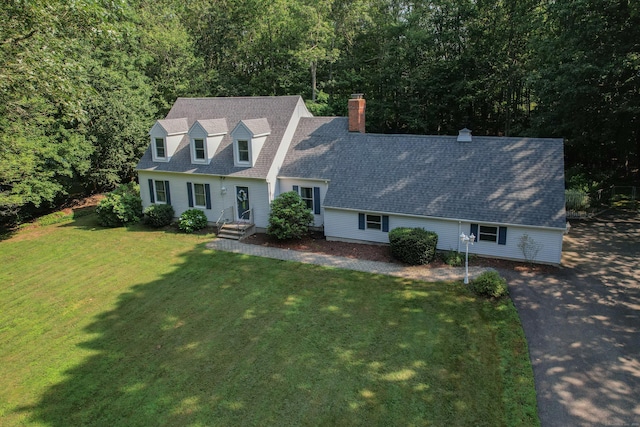 10 Heritage Dr, Prospect, CT 06712 - new england style home featuring a chimney, a front yard, a forest view, and roof with shingles