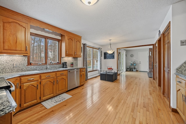 10 Heritage Dr, Prospect, CT 06712 - kitchen featuring dishwasher, brown cabinets, tasteful backsplash, light wood-type flooring, and a textured ceiling