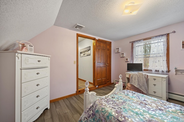 10 Heritage Dr, Prospect, CT 06712 - bedroom with a textured ceiling, wood finished floors, baseboard heating, and vaulted ceiling