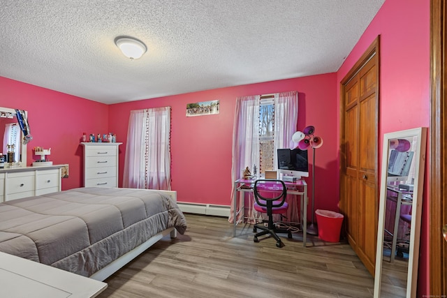 10 Heritage Dr, Prospect, CT 06712 - bedroom featuring a baseboard heating unit, wood finished floors, and a textured ceiling