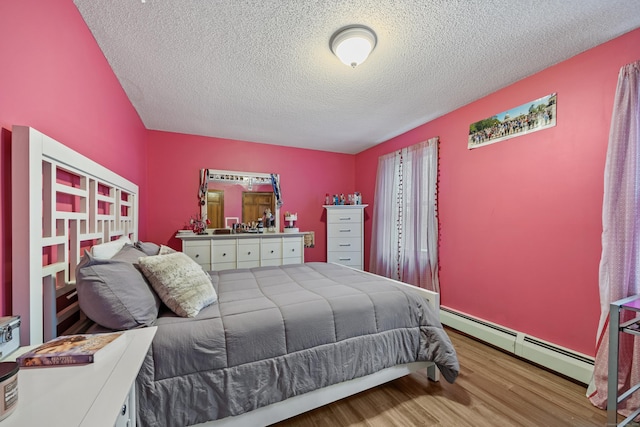 10 Heritage Dr, Prospect, CT 06712 - bedroom featuring baseboard heating, wood finished floors, and a textured ceiling