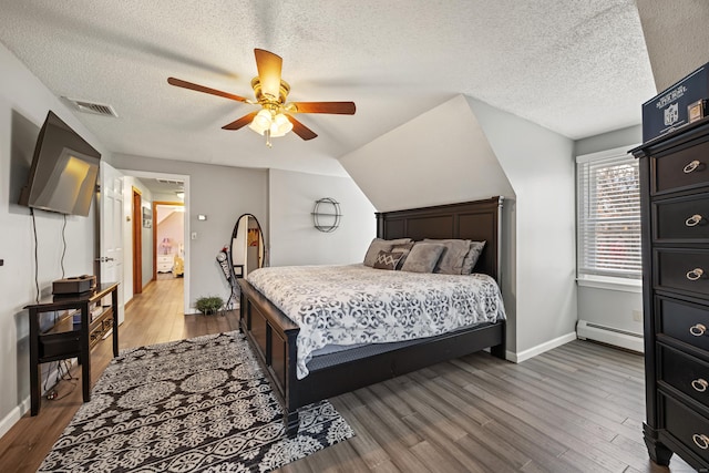 10 Heritage Dr, Prospect, CT 06712 - bedroom with baseboard heating, a textured ceiling, wood finished floors, and ceiling fan