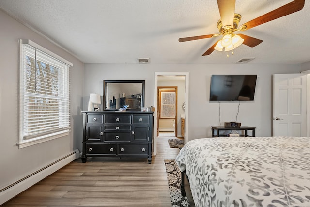 10 Heritage Dr, Prospect, CT 06712 - bedroom with a baseboard heating unit, wood finished floors, and a ceiling fan