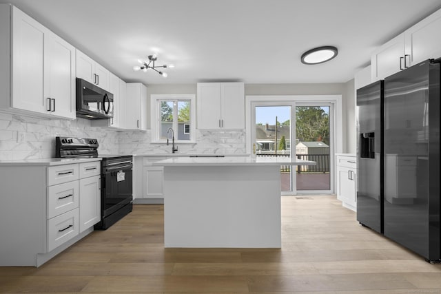 15 Burdette Pl, Milford, CT 06460 - kitchen with stainless steel appliances, tasteful backsplash, light countertops, white cabinetry, and light wood-type flooring
