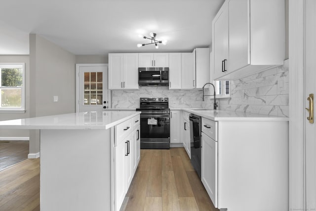 15 Burdette Pl, Milford, CT 06460 - kitchen with stainless steel microwave, electric stove, a kitchen island, and tasteful backsplash