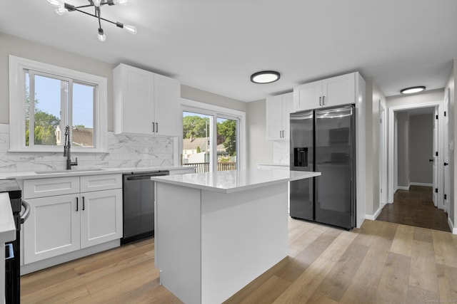15 Burdette Pl, Milford, CT 06460 - kitchen featuring stainless steel appliances, backsplash, light countertops, and white cabinets