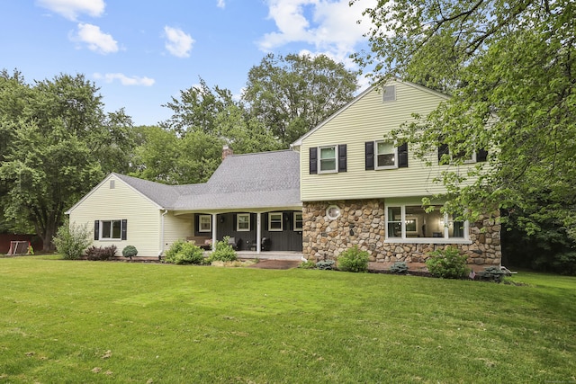 195 Orchard Hill Dr, South Windsor, CT 06074 - view of front of home with stone siding, a front yard, and roof with shingles