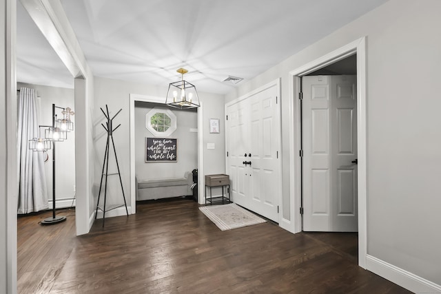 195 Orchard Hill Dr, South Windsor, CT 06074 - foyer with a chandelier, dark wood finished floors, and baseboard heating