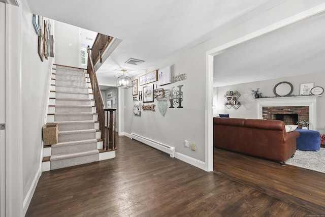 195 Orchard Hill Dr, South Windsor, CT 06074 - living room with a baseboard heating unit, wood finished floors, stairway, and a fireplace