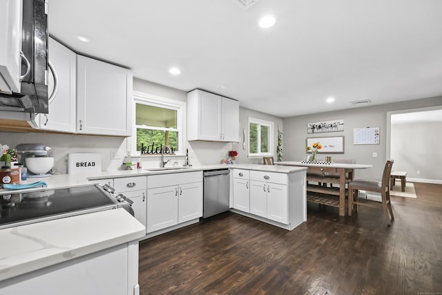 195 Orchard Hill Dr, South Windsor, CT 06074 - kitchen featuring stainless steel appliances, light countertops, dark wood-style flooring, white cabinetry, and a peninsula