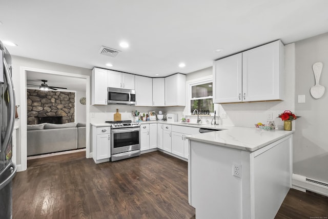 195 Orchard Hill Dr, South Windsor, CT 06074 - kitchen with stainless steel appliances, a ceiling fan, dark wood-type flooring, white cabinetry, and a peninsula
