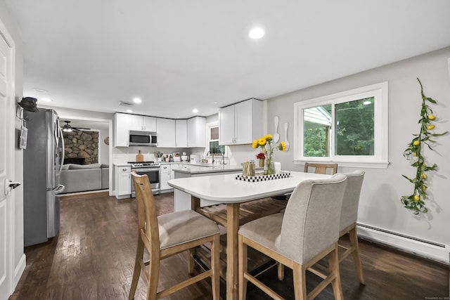 195 Orchard Hill Dr, South Windsor, CT 06074 - dining room featuring a baseboard radiator, dark wood finished floors, recessed lighting, and a fireplace