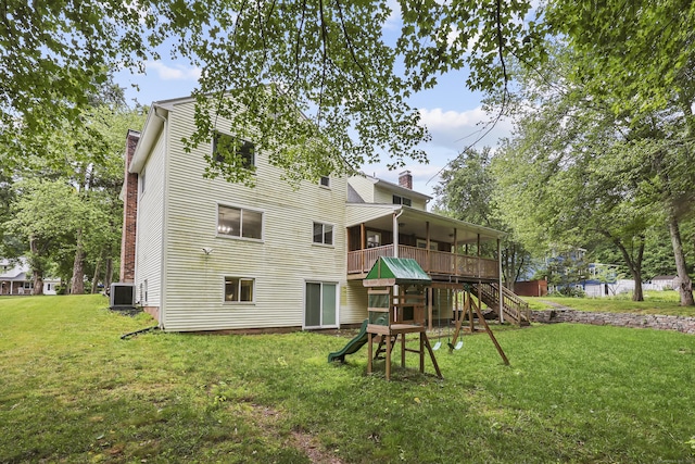 195 Orchard Hill Dr, South Windsor, CT 06074 - back of house with a chimney, a playground, and a lawn