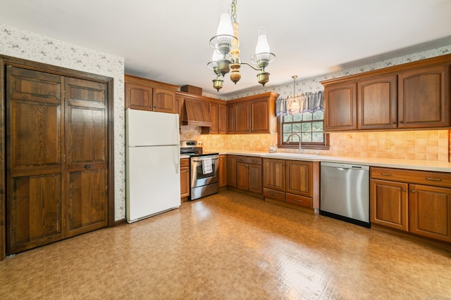 6 Revere Rd, New Milford, CT 06776 - kitchen featuring stainless steel appliances, a chandelier, light countertops, wallpapered walls, and tasteful backsplash