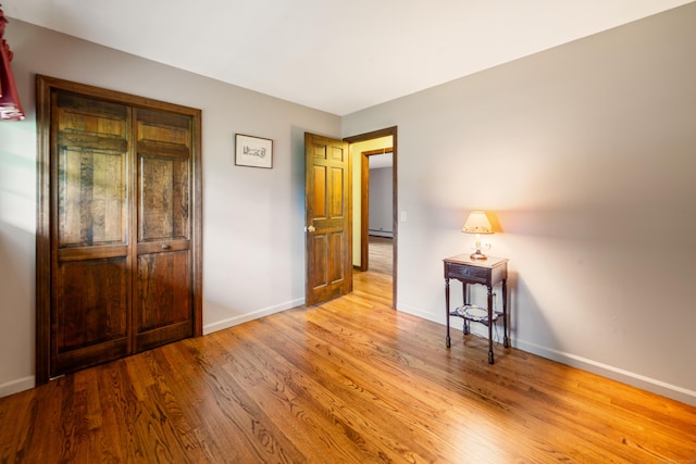 6 Revere Rd, New Milford, CT 06776 - bedroom with wood finished floors and a baseboard heating unit