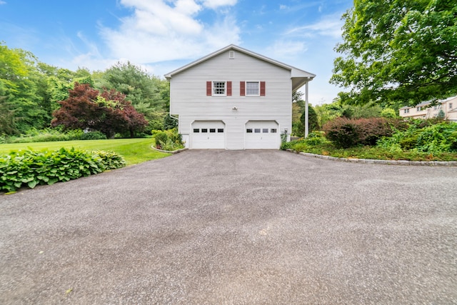 6 Revere Rd, New Milford, CT 06776 - view of side of home featuring an attached garage, driveway, and a lawn