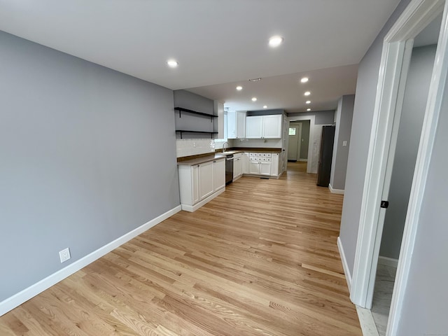 654 Nichols Ave, Stratford, CT 06614 - kitchen featuring open shelves, dark countertops, light wood-type flooring, stainless steel dishwasher, and recessed lighting