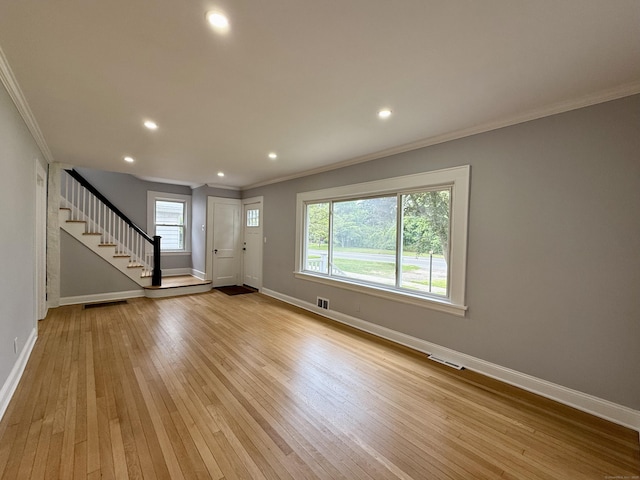 654 Nichols Ave, Stratford, CT 06614 - unfurnished living room featuring crown molding, stairway, light wood-style floors, and recessed lighting