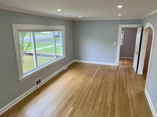 654 Nichols Ave, Stratford, CT 06614 - unfurnished room featuring arched walkways, light wood-style floors, ornamental molding, and recessed lighting