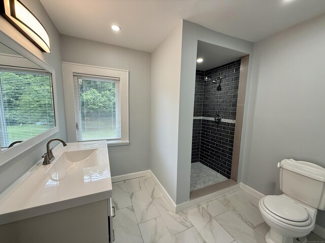 654 Nichols Ave, Stratford, CT 06614 - full bath with marble look tiles, a tile shower, vanity, and recessed lighting