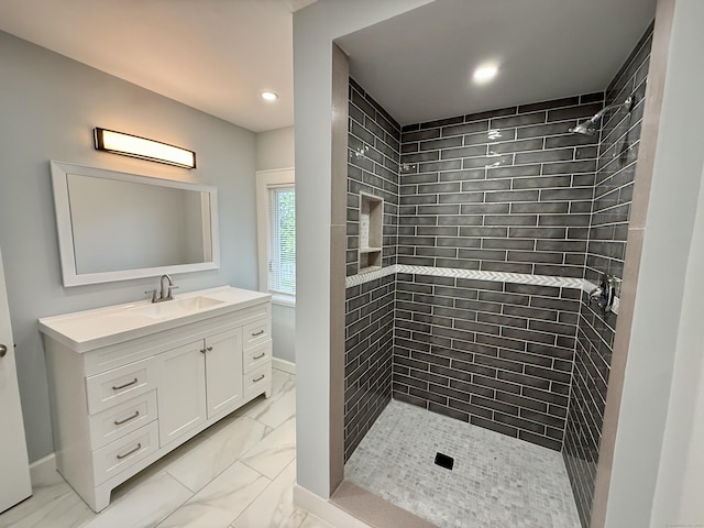 654 Nichols Ave, Stratford, CT 06614 - full bathroom featuring marble look tiles, a tile shower, vanity, and recessed lighting