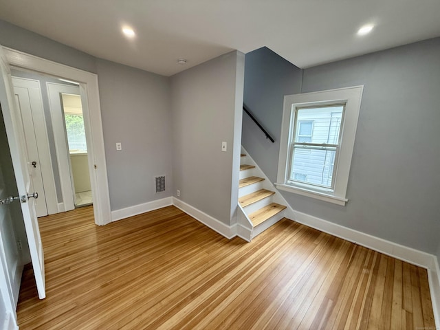 654 Nichols Ave, Stratford, CT 06614 - spare room featuring light wood-type flooring, stairway, and recessed lighting