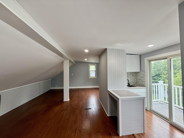654 Nichols Ave, Stratford, CT 06614 - kitchen featuring tasteful backsplash, wood finished floors, light countertops, white cabinetry, and lofted ceiling