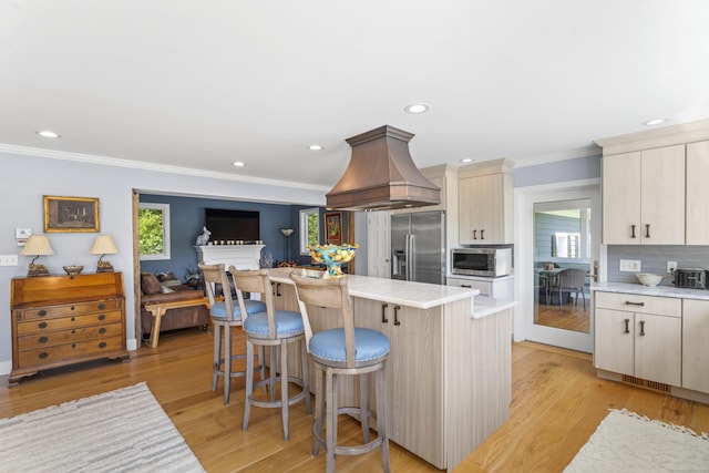 168 Cobble Rd, Kent, CT 06757 - kitchen with stainless steel appliances, island exhaust hood, crown molding, light countertops, and a kitchen island