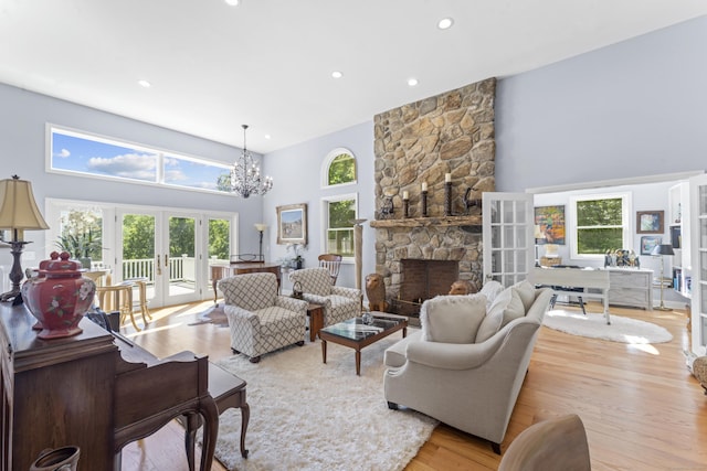 168 Cobble Rd, Kent, CT 06757 - living area with french doors, a towering ceiling, healthy amount of natural light, light wood-style floors, and a chandelier