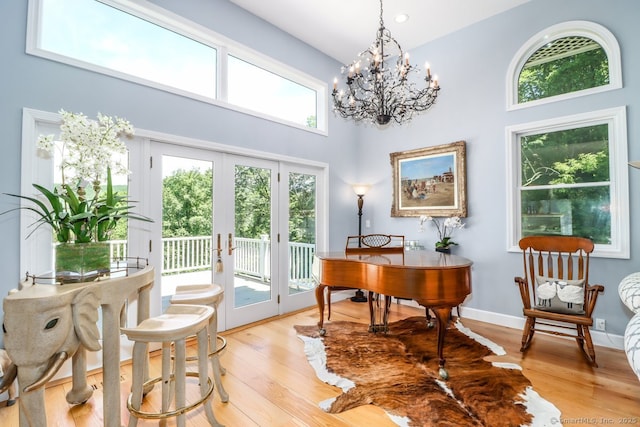 168 Cobble Rd, Kent, CT 06757 - office area with french doors, light wood-style floors, a chandelier, and a high ceiling