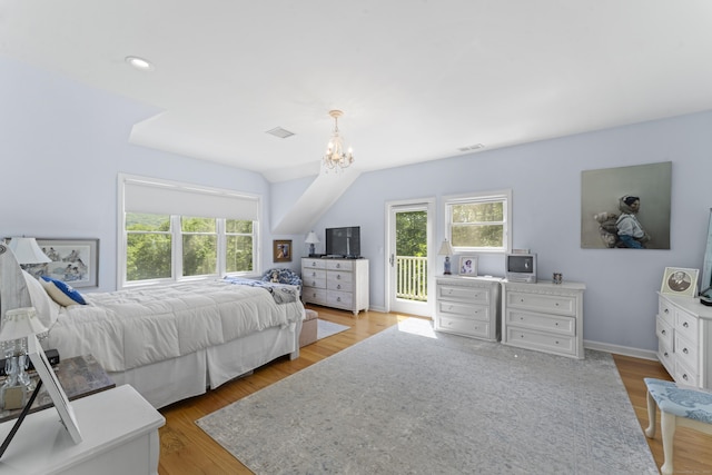 168 Cobble Rd, Kent, CT 06757 - bedroom featuring multiple windows, access to exterior, a chandelier, wood finished floors, and vaulted ceiling